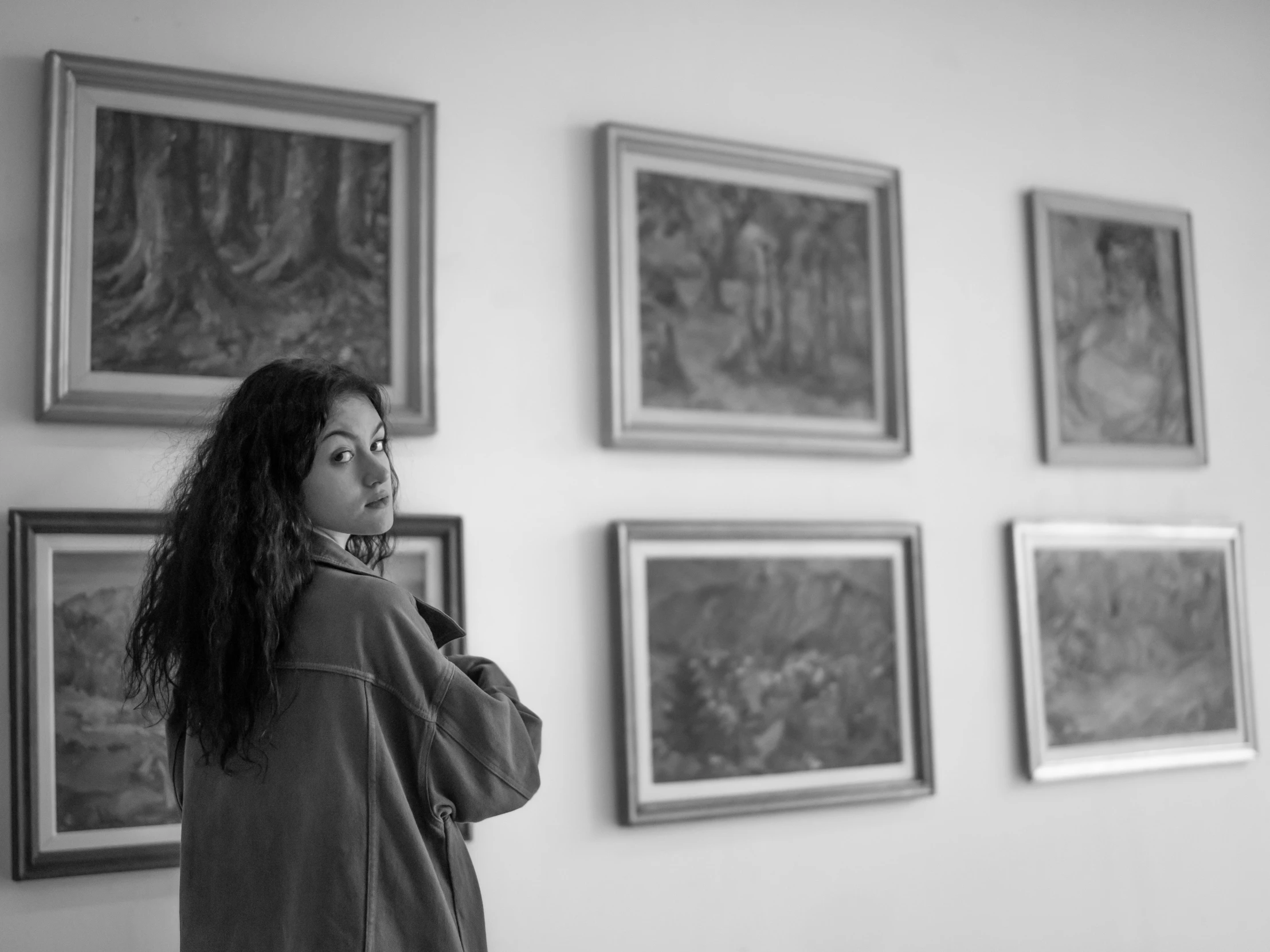 a woman in a black and white po looking up into the sky