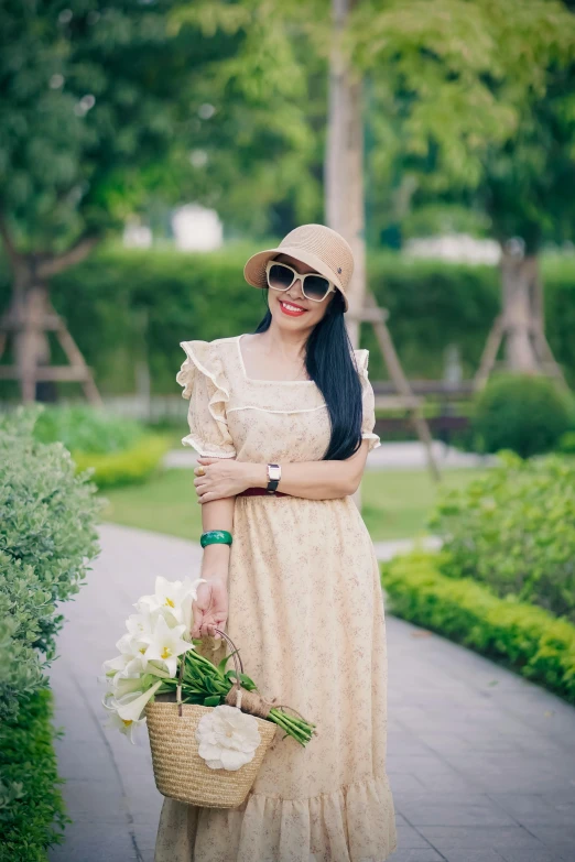 a woman is dressed in an old fashion dress and holds flowers