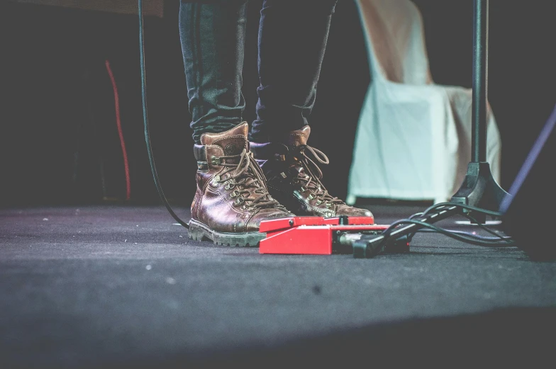 a person standing on a stage in front of a microphone