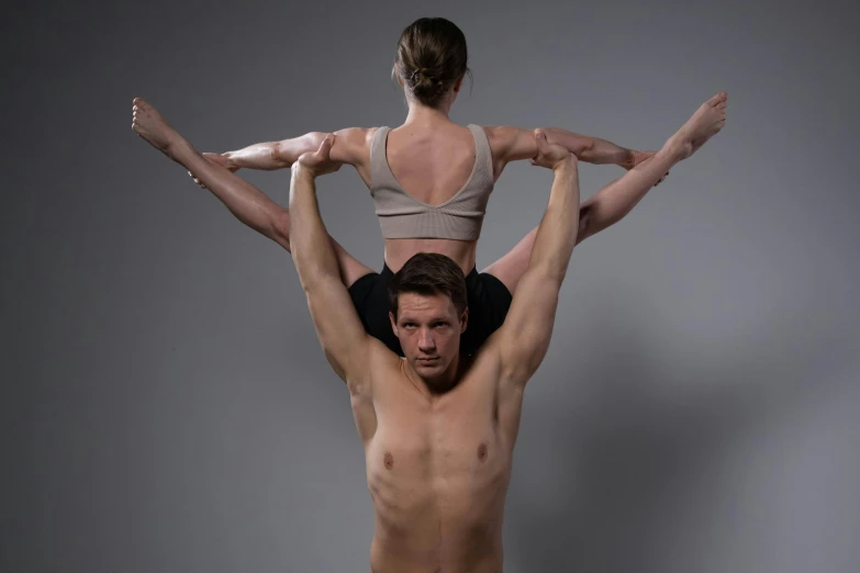 a woman is hanging on top of a man