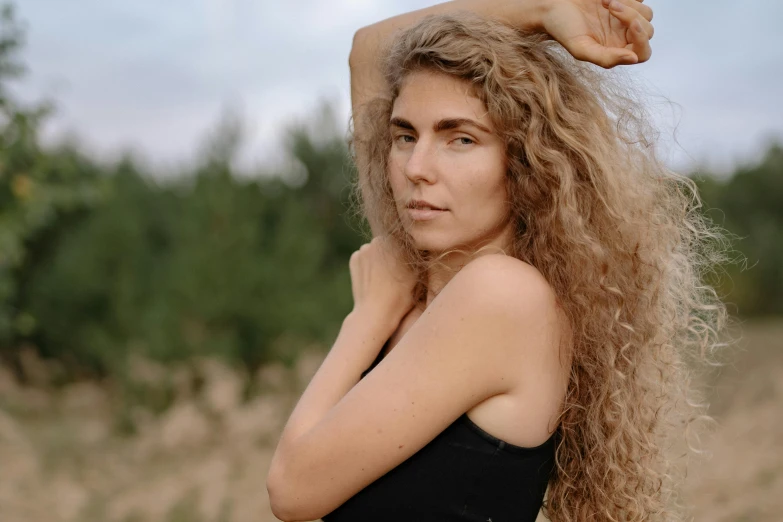 a woman with long hair and a black shirt