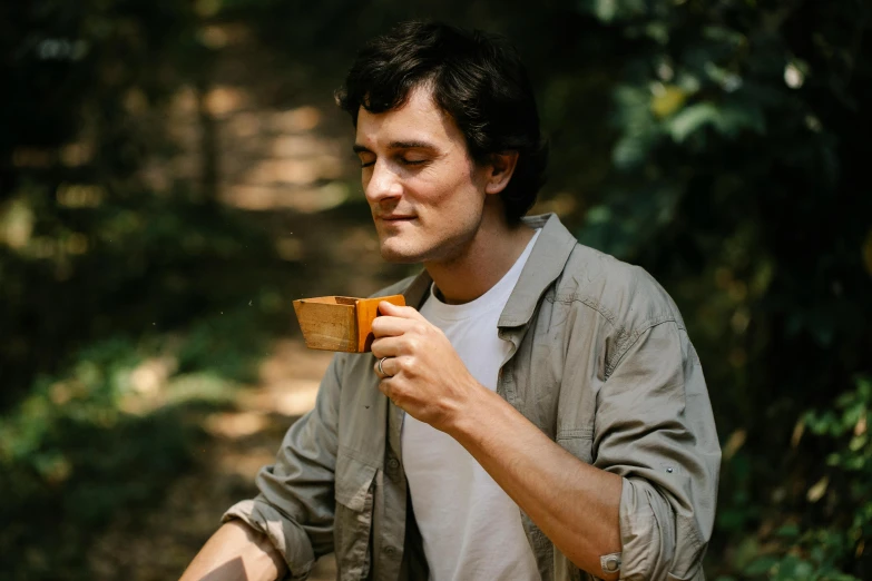 a man holding a small wood block in his hands