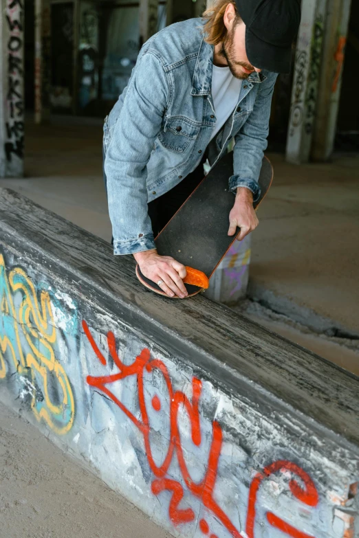 a man is on the edge of a skateboard ramp and working on his skate board