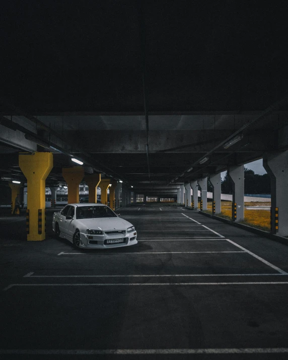 two cars are parked in an empty parking lot