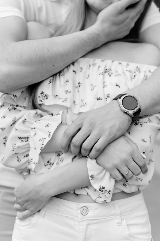 a woman in white shirt holding a baby