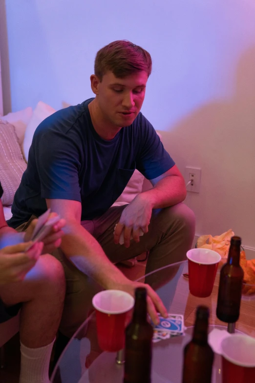 a man sitting down holding a remote playing video games