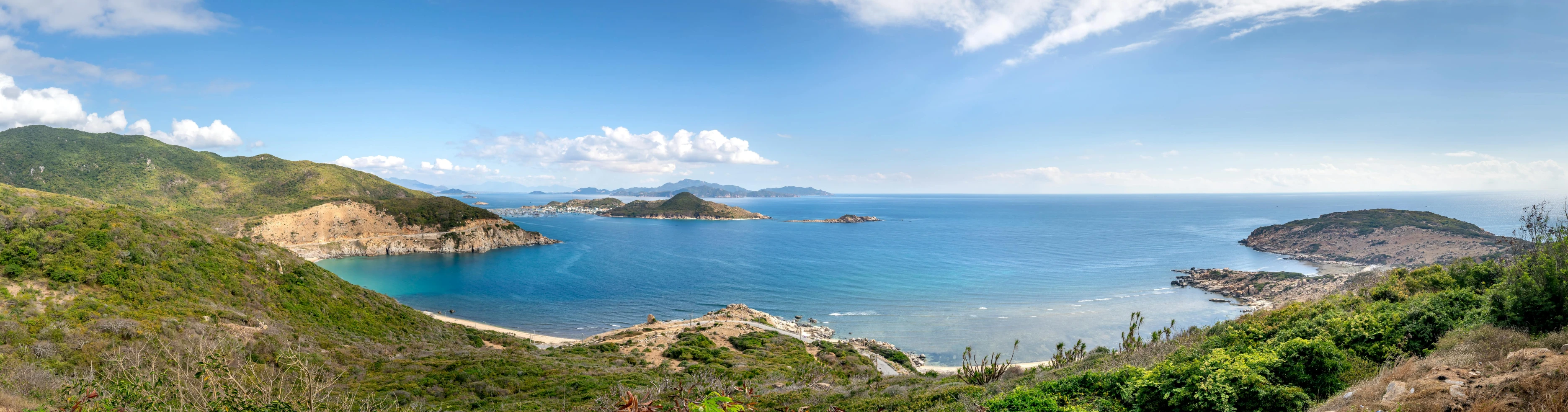 the view over a mountain that leads to the beach