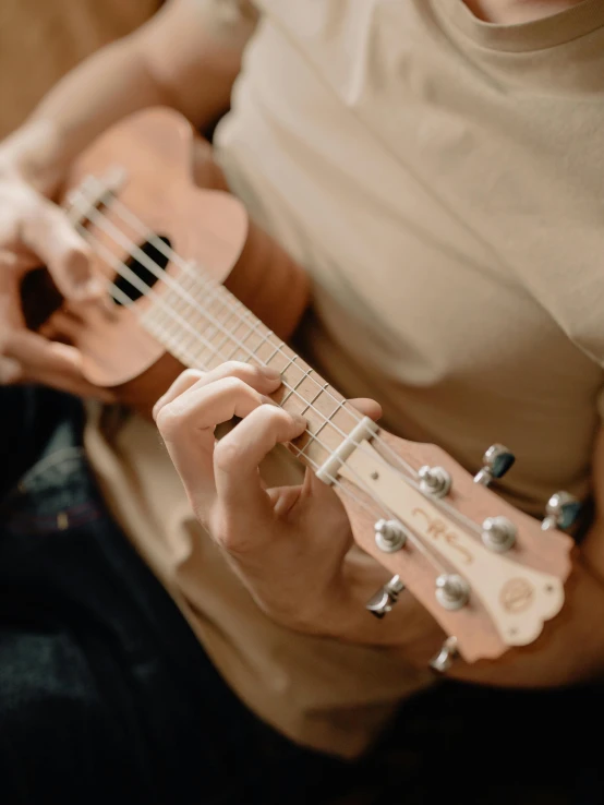 a man is holding a guitar and playing it