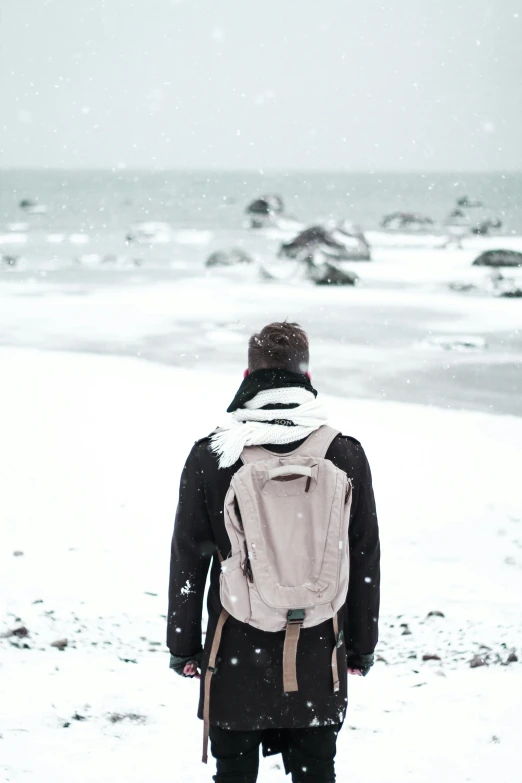 a man standing on top of snow covered ground