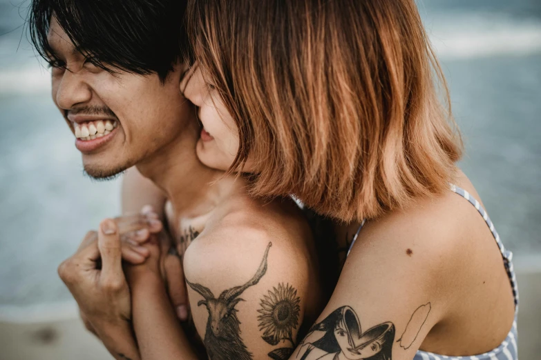 a couple holding each other by the water