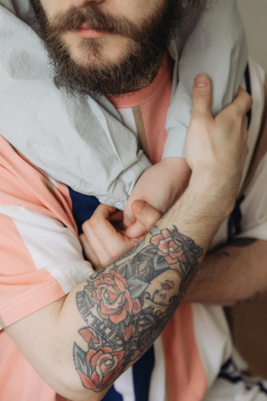 a man with a tattoo on his arms poses for the camera