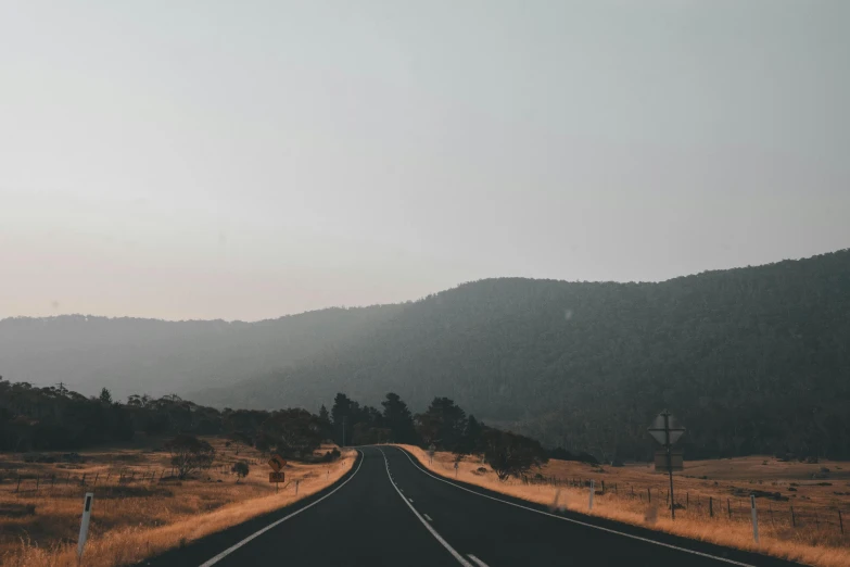 a scenic s of an empty road on an overcast day