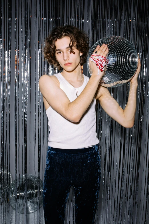 a man holding a fan up to his face