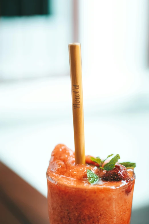 a drink with a straw on top sits in front of the camera