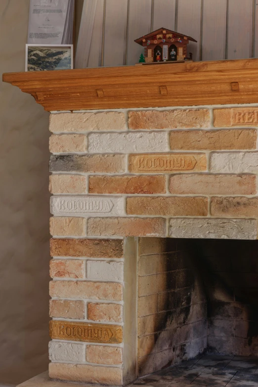 an open fire place with wooden mantle and shelves above it