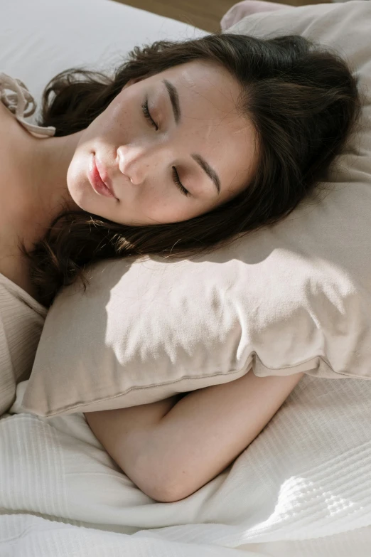 a woman laying in bed with her eyes closed