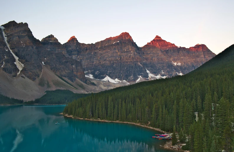 some large mountains next to a body of water