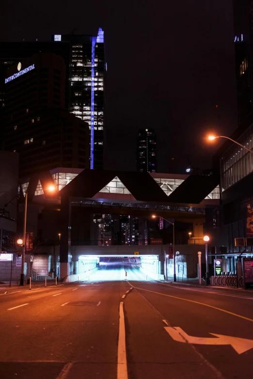 dark city street at night with lights on