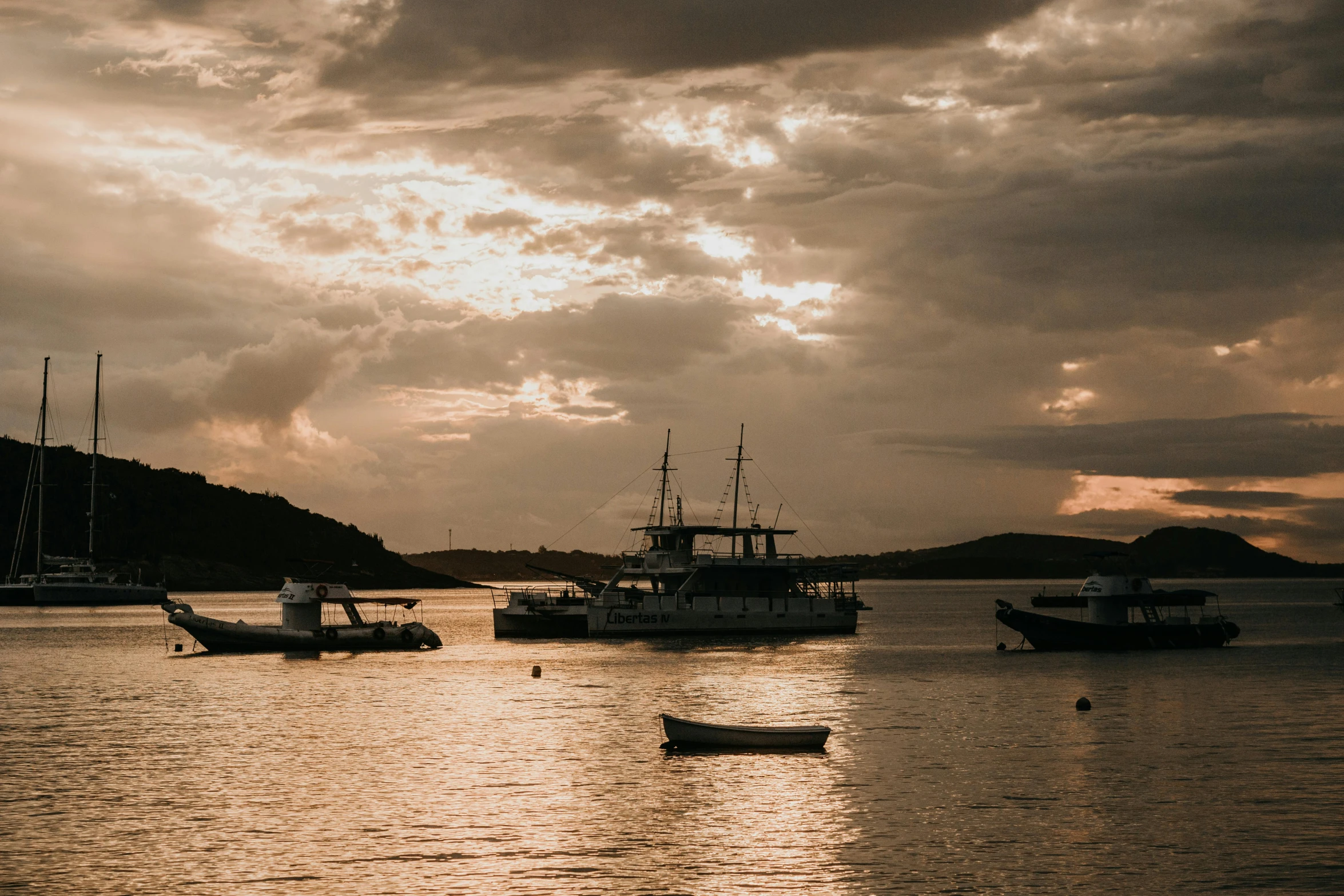 a number of boats in the water near one another