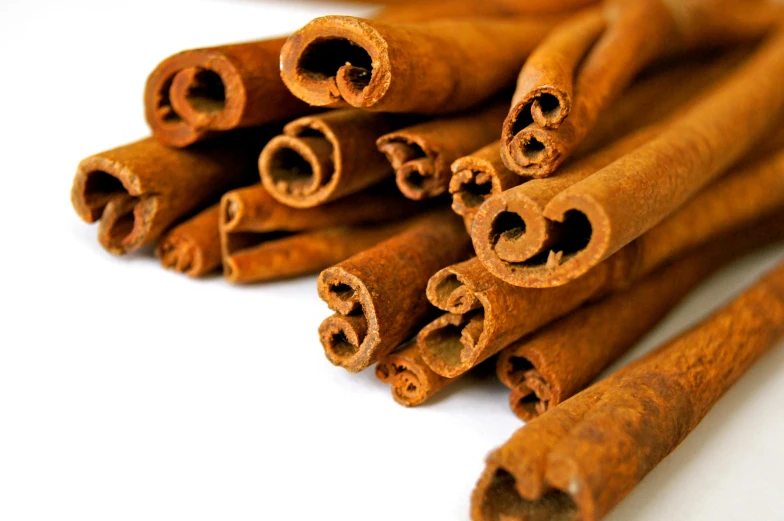 several cinnamon sticks lay on the floor next to each other