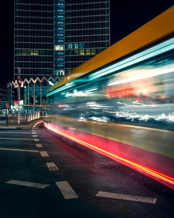 an urban road with traffic on it at night