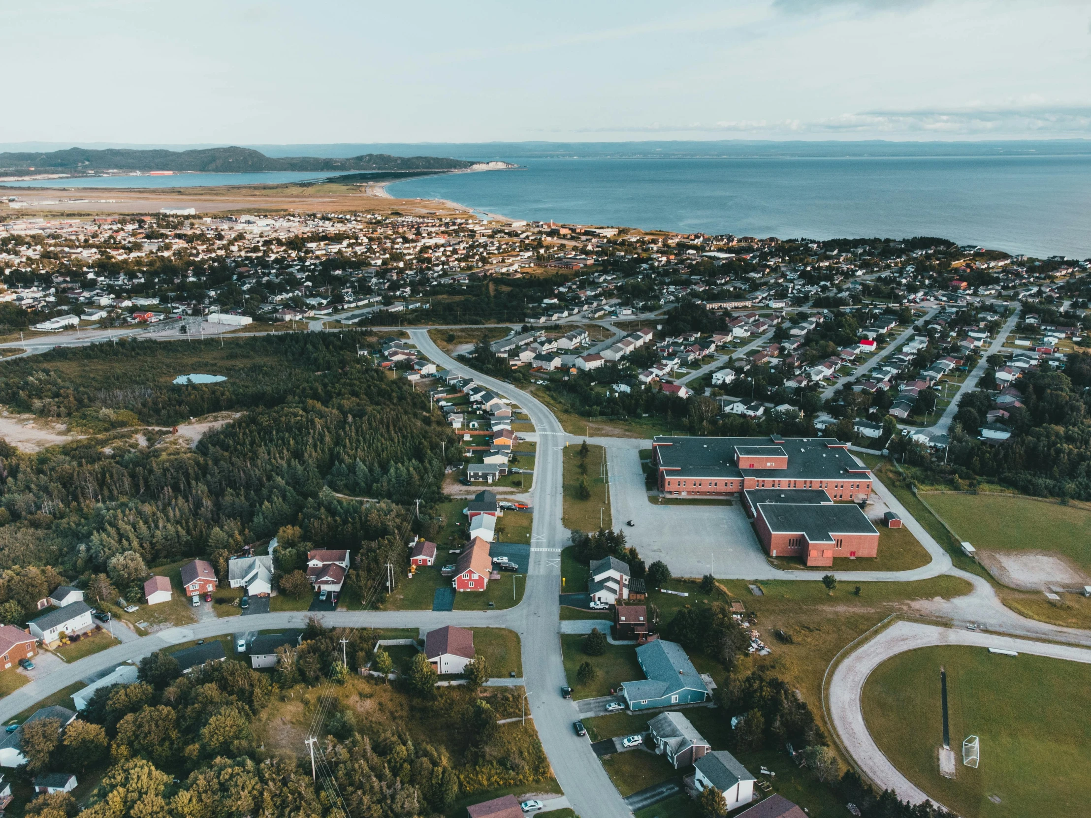 an aerial view of a neighborhood by the water