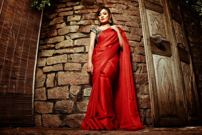 woman in a long red dress posing for a po