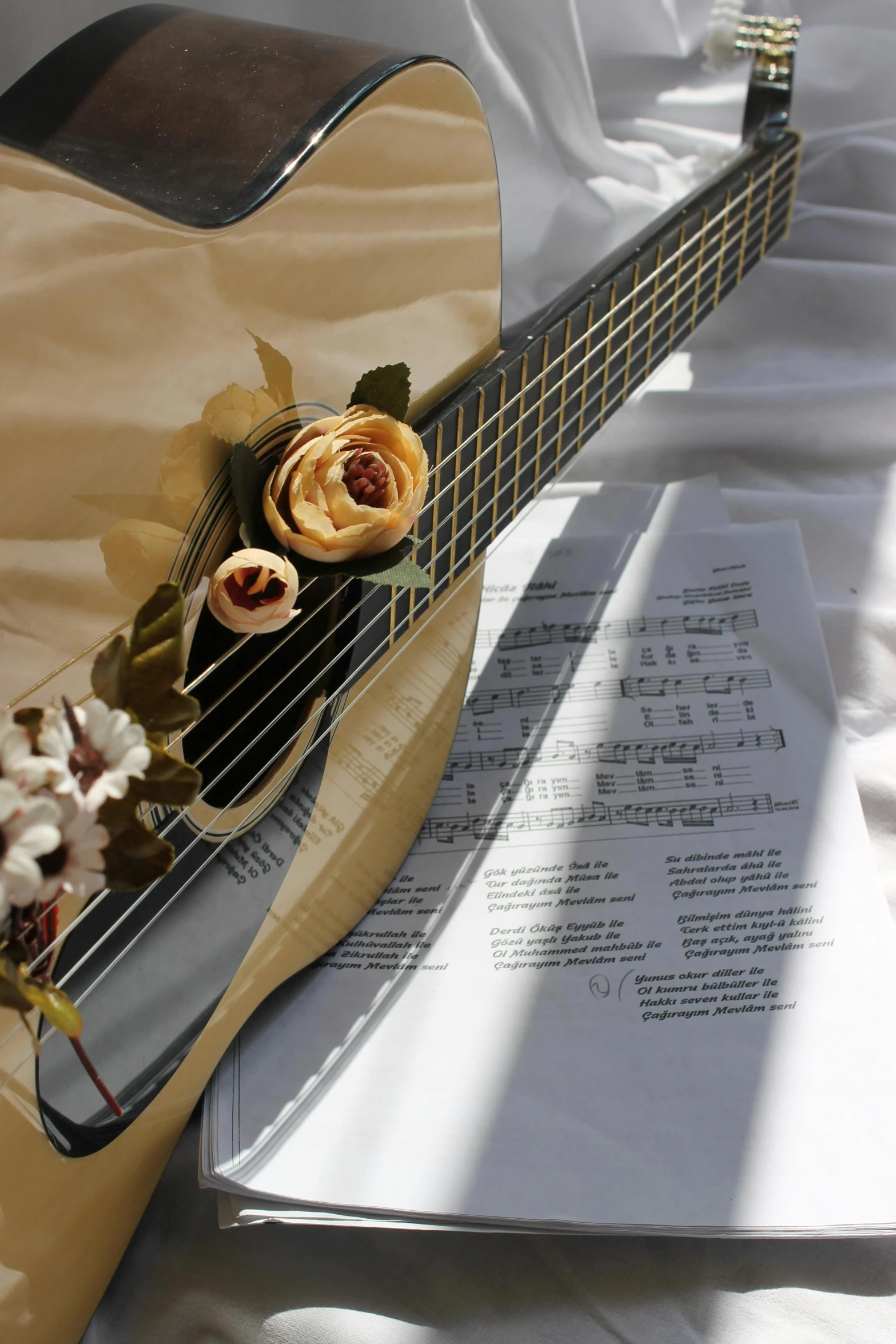 a small guitar with flowers on the neck