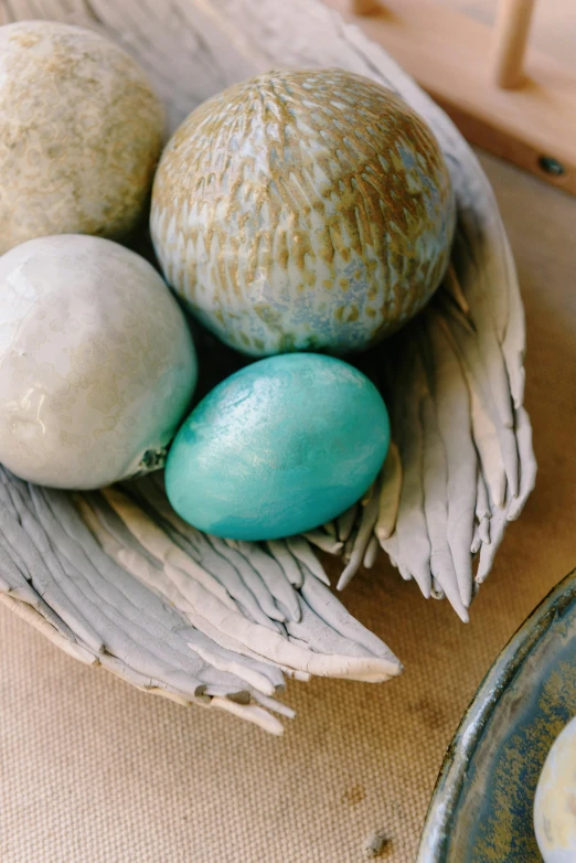 a basket filled with different types of colored eggs