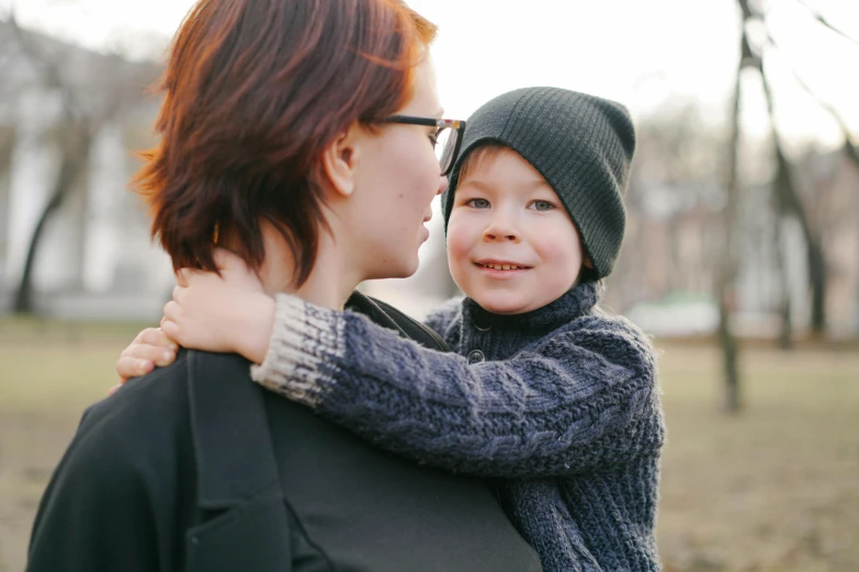 a lady and her son having fun in a park