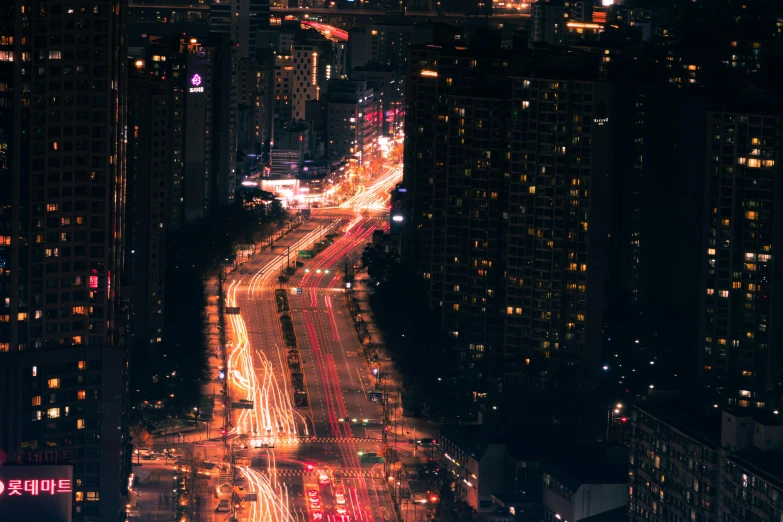 cars traveling through city in the night time