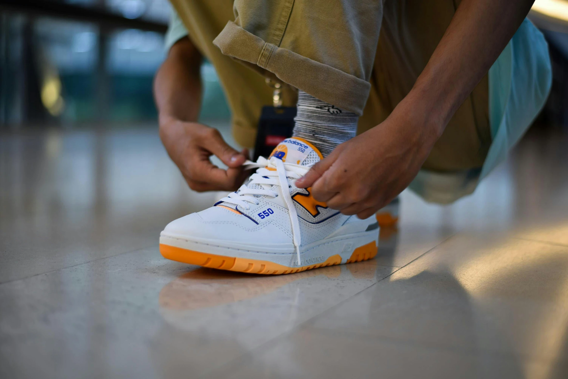 the legs of a man tying up sneakers