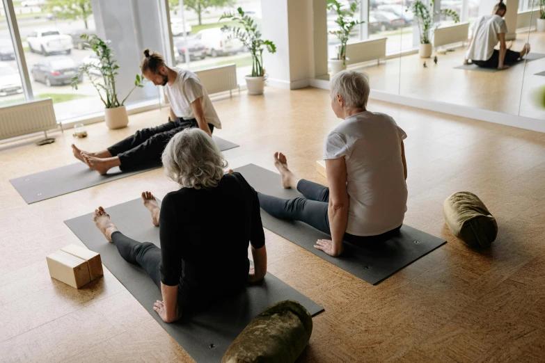 a group of people on yoga mats doing exercises