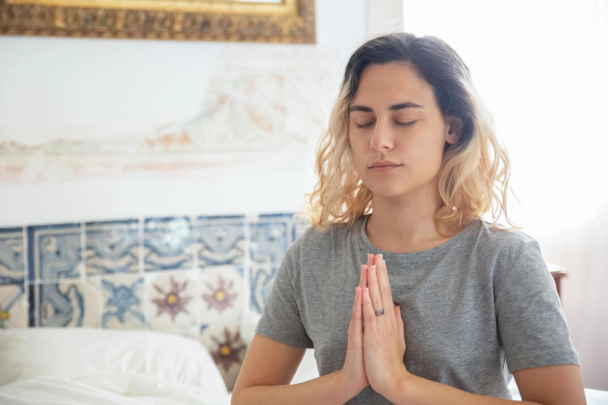 a woman doing yoga with her hands in prayer