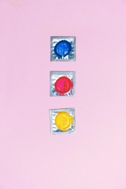 two colorful candy candies in a pink envelope