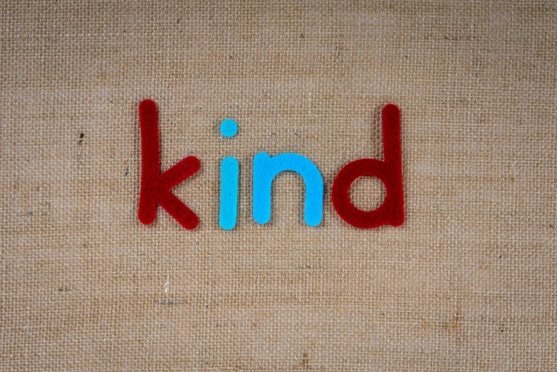 the words kind are painted on an area rug