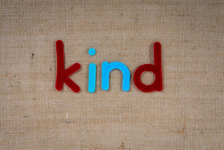 the words kind are painted on an area rug