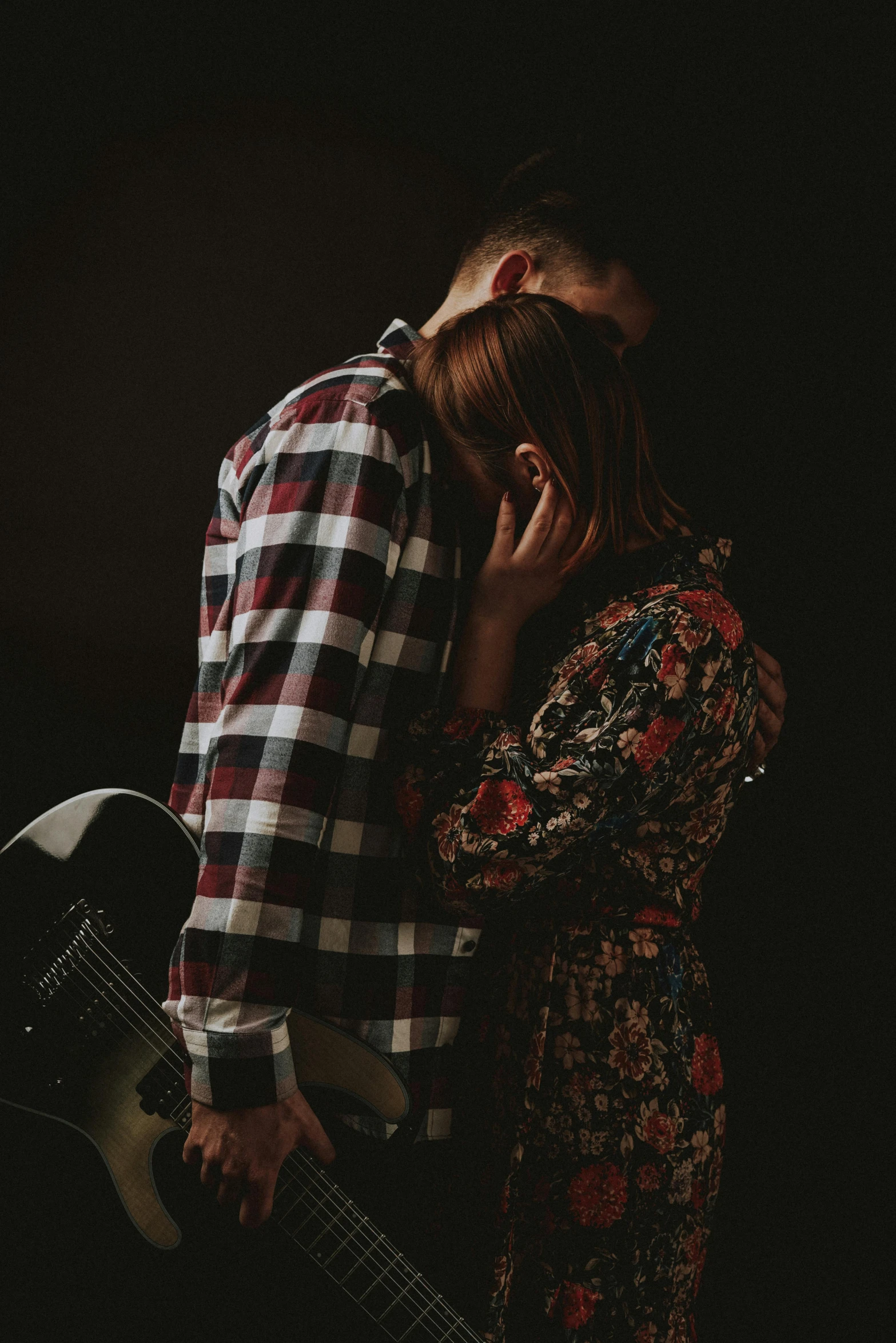 a man standing next to a woman who is covering her face with her hands