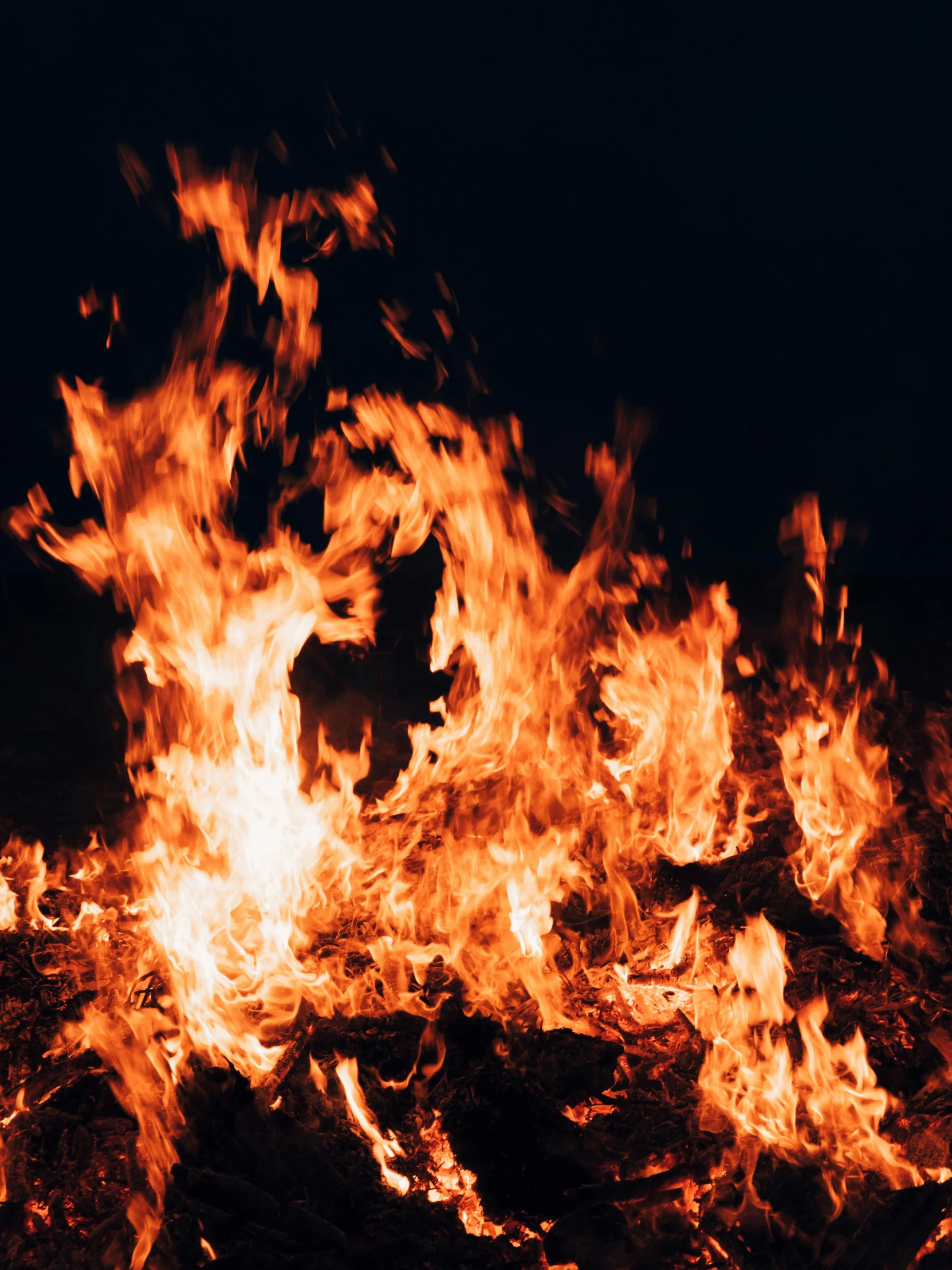 a bunch of fire blazing on top of a field