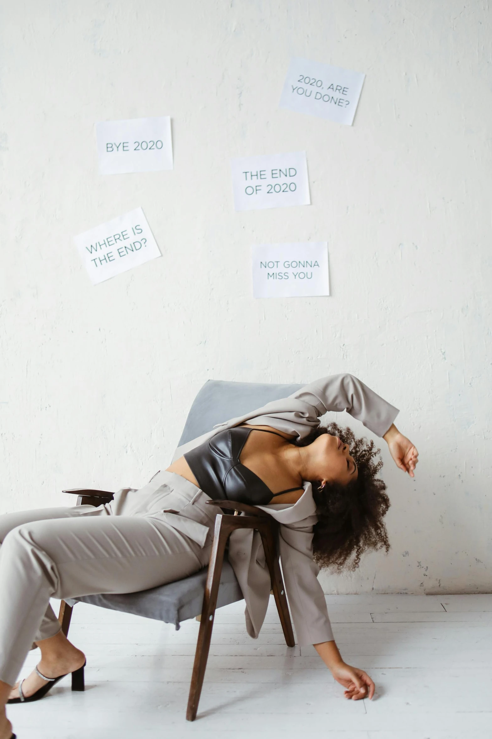 the business woman is sitting on a chair with her head on her hand