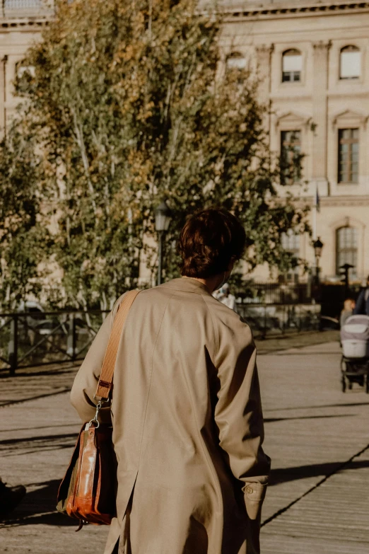 a woman walking down the street with her purse