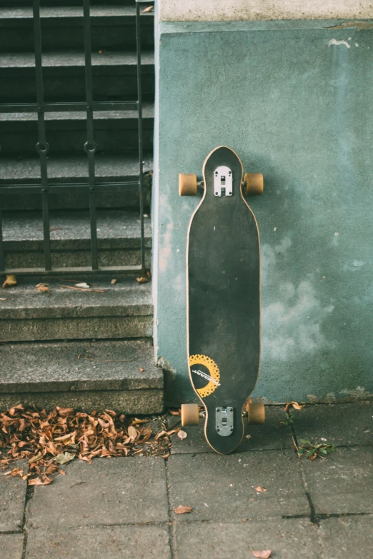 a skateboard propped up against the wall outside of a building