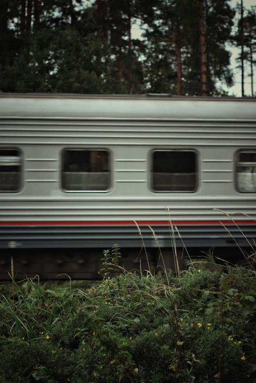 train on a railroad track next to grass