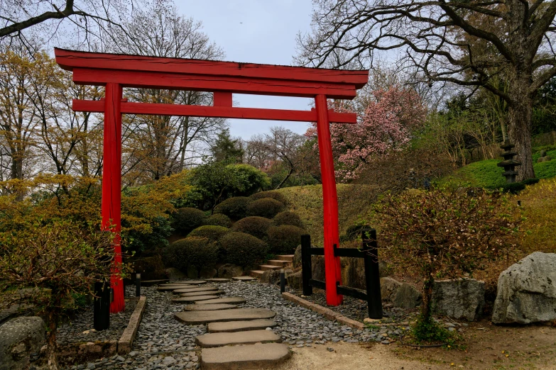 a red gate in the middle of a small path