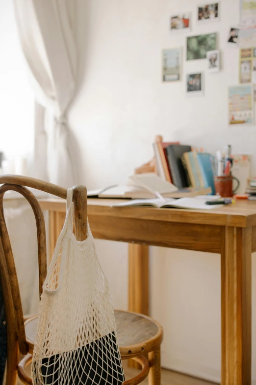 the net bags are hanging on the chair by the table