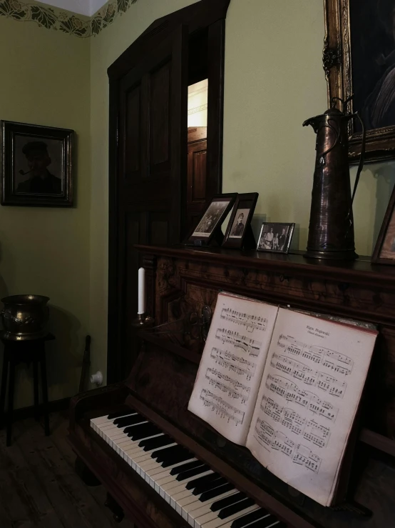 an old wooden piano with a sheet on it