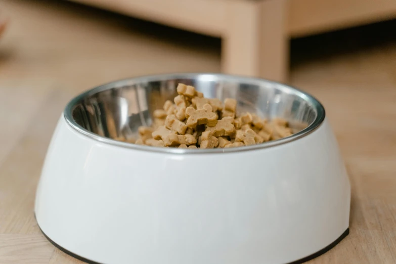 a white bowl filled with food sitting on top of a table