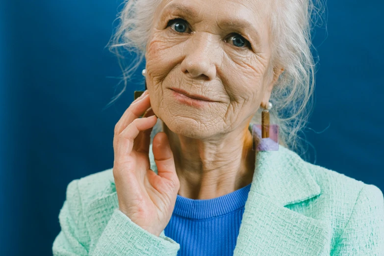 an old woman holding a cellphone up to her ear