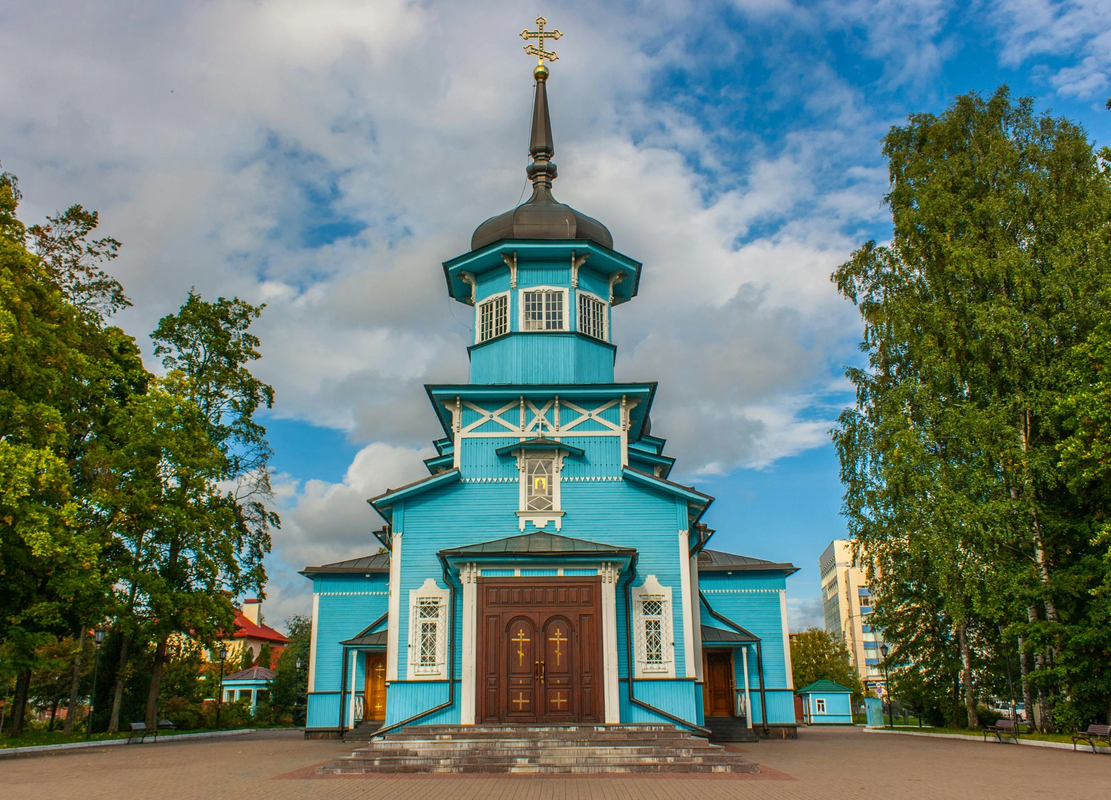 a small blue church with a steeple and windows