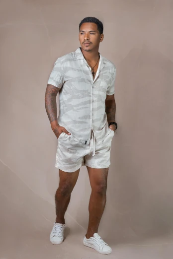 a man in white shorts posing for a po